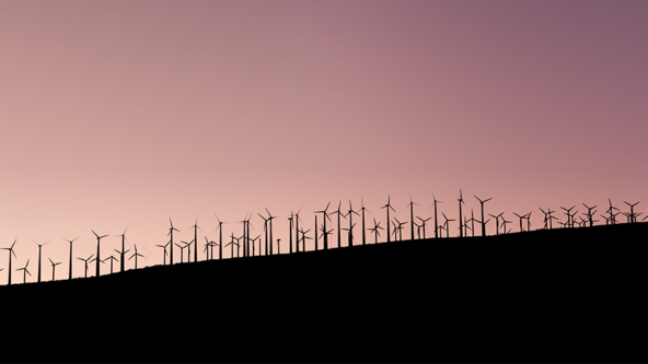 Shadow of wind farms on sunset